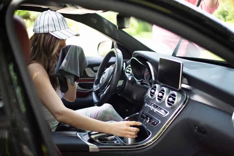 Melissa with microfiber cloth and tea in her car