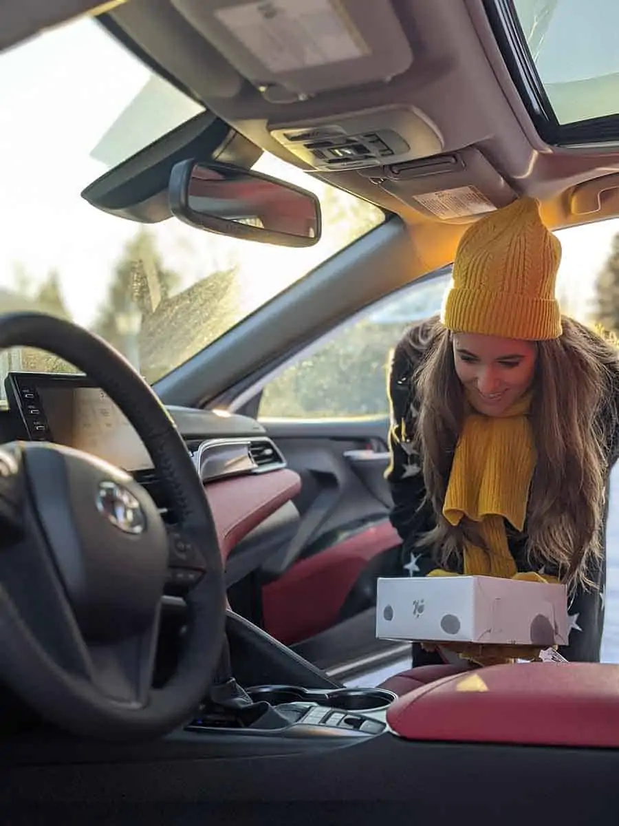 Melissa putting a box of food into her car